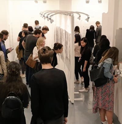 A busy private view in a pop-up gallery